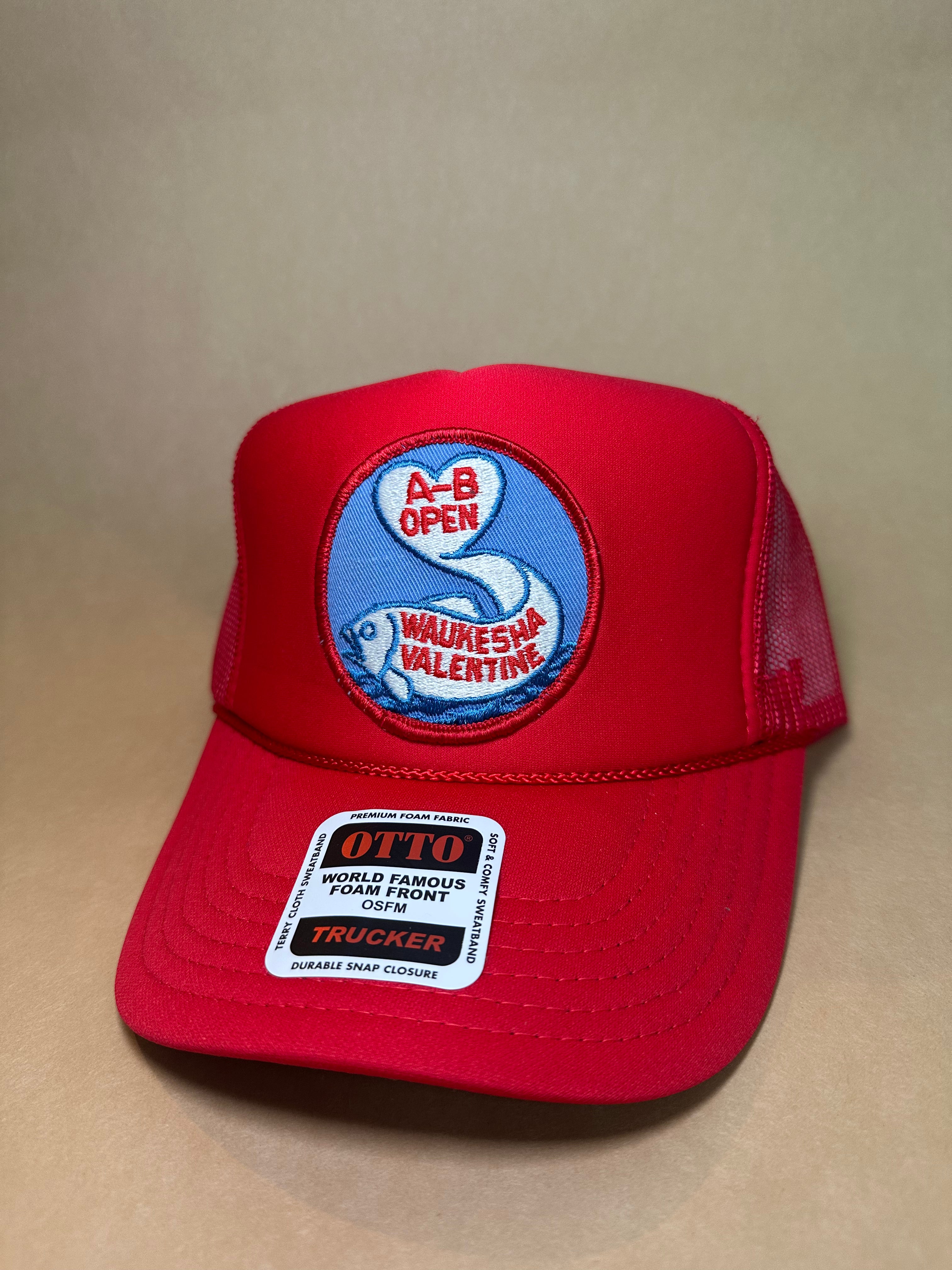 Red trucker cap with a patch on a beige background